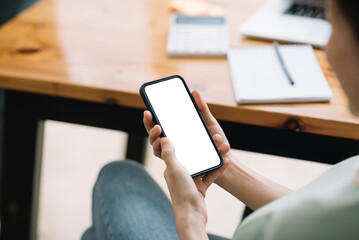 Person holding a modern smartphone with a blank screen, ready for design. Concept for mobile technology, communication, and online connectivity.