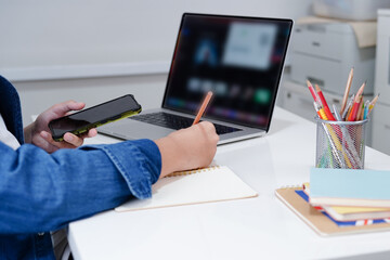 Asian teenage student write homework with laptop computer, learning university education concept.