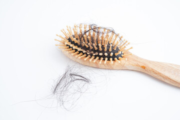 Hair loss fall with comb brush isolated on white background.