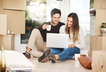 Boxes, happy couple on floor and laptop with online shopping for furniture, internet research and...