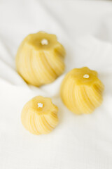 Handmade candles made from natural beeswax on a white background. Hobby. Beekeeping. Small business.