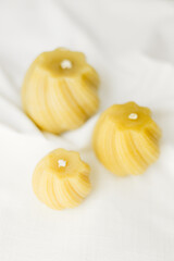 Handmade candles made from natural beeswax on a white background. Hobby. Beekeeping. Small business.