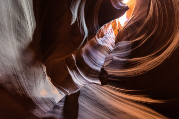 Upper Antelope Canyon, near Page, Arizona, is a breathtaking slot canyon known for its narrow passageways and vibrant sandstone walls.
