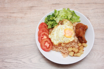 Fried rice with tomato sauce Or as we call it American fried rice Served with fried eggs, fried chicken, fresh stir-fry, and fried bread.