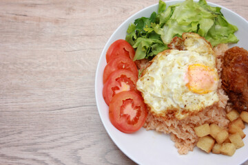 Fried rice with tomato sauce Or as we call it American fried rice Served with fried eggs, fried chicken, fresh stir-fry, and fried bread.