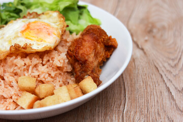 Fried rice with tomato sauce Or as we call it American fried rice Served with fried eggs, fried chicken, fresh stir-fry, and fried bread.