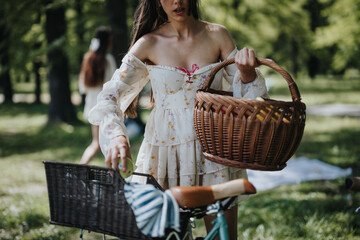 Elegantly dressed young girl prepares for a picnic by placing a traditional wicker basket on her...