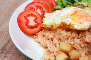 Fried rice with tomato sauce Or as we call it American fried rice Served with fried eggs, fried chicken, fresh stir-fry, and fried bread.