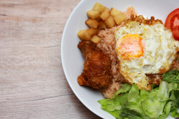 Fried rice with tomato sauce Or as we call it American fried rice Served with fried eggs, fried chicken, fresh stir-fry, and fried bread.