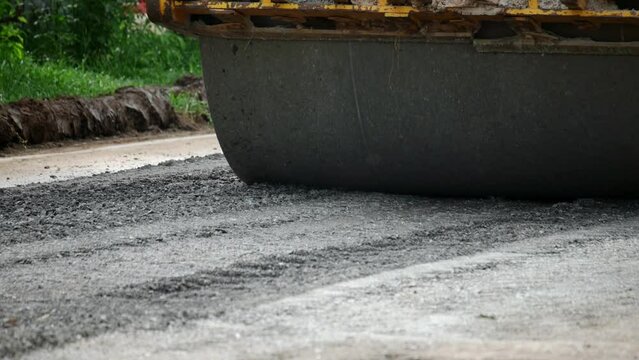 Yellow steamroller on road, Using roller compactor for road construction and asphalt finishing, Concept Road Construction, Roller Compactor, Asphalt Finishing, Construction Machinery