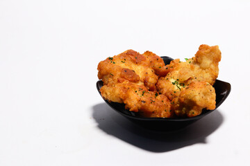 Crispy fried chicken on a small plate isolated on white