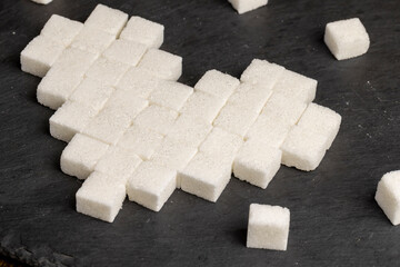 white square sugar on a black background