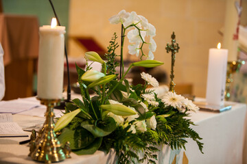 Beautiful floral arrangement with white flowers and candles, captured in a serene setting under...