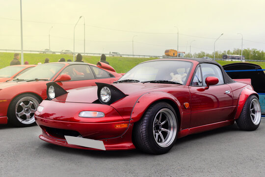 Russia, Novosibirsk, 25.05.2024 Midday, Red Mazda Miata MX-5 Roadster 1989, in tuning, Rocket Bunny Rear Bumper Extensions