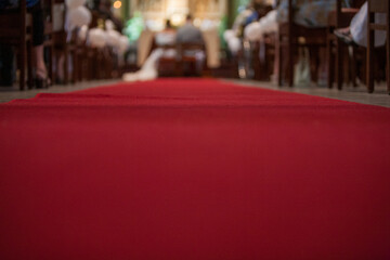 A beautifully designed wedding aisle features a red carpet leading to the altar, ready for a...