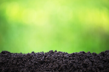 soil against the background of blurred plants, pile of fertile ground