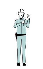 Female engineer in helmet and work wear recommending credit card payment.