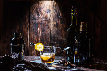 Prepared cocktail on the table. Cocktail and bottles. Shaker and bartender spoon. Cocktail...