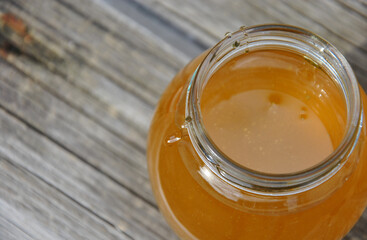 honey in a glass. open jar with fresh honey close-up. selective focus. top view