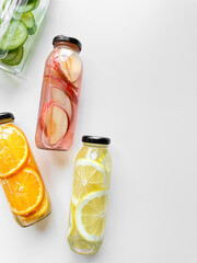 Variety detox drinks in glass bottles on white background, with copy space. Healthy lifestyle and...