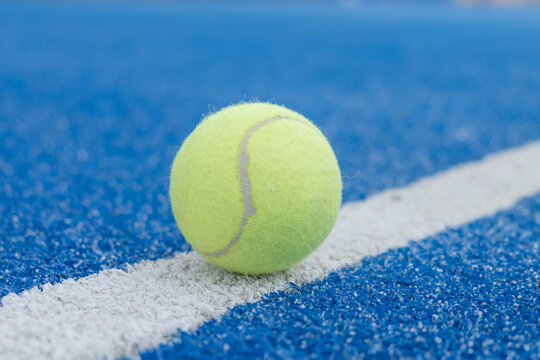 paddle tennis ball in a blue court, selective focus