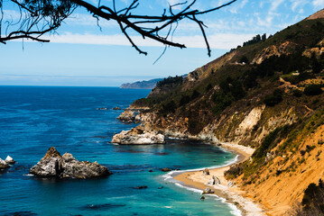 view of Monterey Bay coastline with turquoise waters and rocky cliffs.