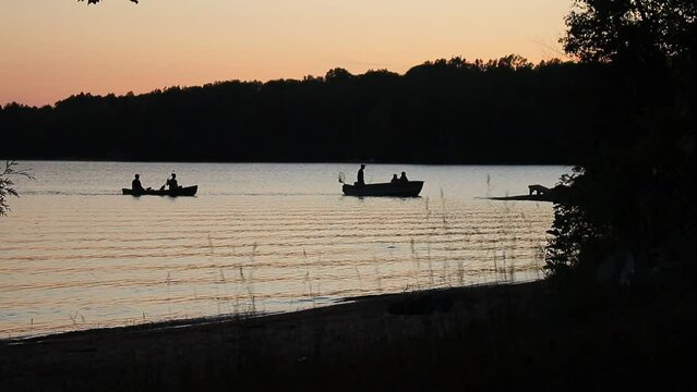 silhouette of fish boats docking at shore