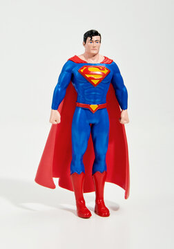 Superman cartoon character standing in white studio