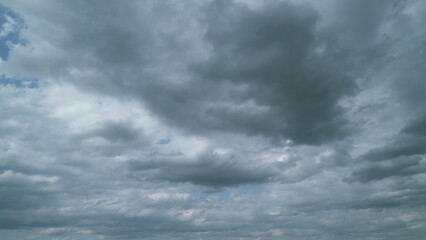 Obraz premium Cumulus clouds moves in the blue sky. Dark huge cloud in sky. Change of weather. Timelapse.