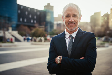 Businessman, mature and arms crossed with portrait in city for business travel for commuting, downtown and outdoor for job. Male entrepreneur or lawyer, confident and happy for corporate career.