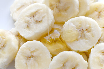 Banana slices with pouring honey. Health and dietary food.