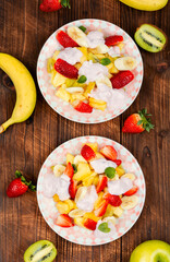 Fruit salad with yogurt on a plate.
