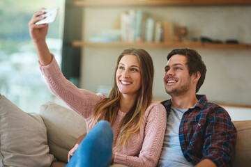 Couple, selfie and smile in house on sofa for relax, social media and holiday together. Man, woman...