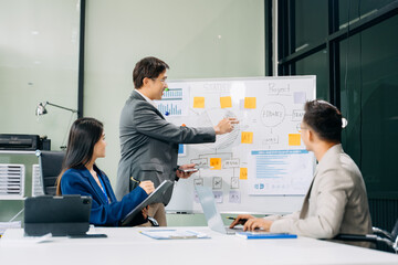 Office colleagues have a casual discussion. During a meeting in a conference room, a group of business teem