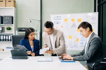 Office colleagues have a casual discussion. During a meeting in a conference room, a group of business teem
