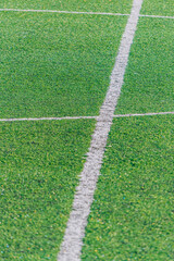 Obraz premium detail of the center line in a synthetic grass surface of a football field