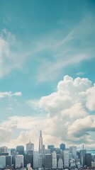 City skyline with high-rise buildings under a vibrant blue sky with scattered white clouds