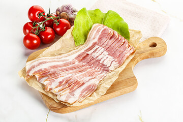 Sliced pork bacon oved board