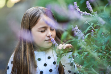 Garden, girl and plant with scent for smell, natural aroma and fragrance in countryside. Park,...