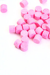  Musk sweet pellets scattered on white with copy space