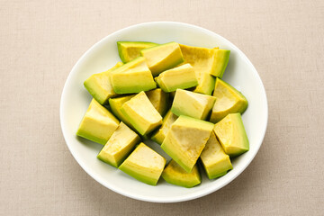 Slice of Alpukat or Avocado (Persea americana), ripe and fresh, served in white plate
