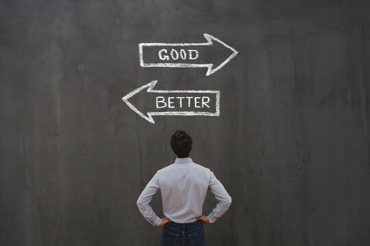 comparison, optimization and improvement concept, good vs better arrows on chalkboard
