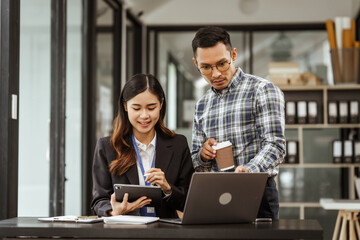Young businesswoman and other Asian individuals are seen working at desks. Accountability,...