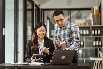 Young businesswoman and other Asian individuals are seen working at desks. Accountability, faultfinding, negligence, and other aspects of recruitment, staffing, and talent management being discussed.