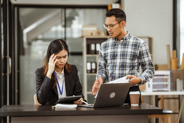 Young businesswoman and other Asian individuals are seen working at desks. Accountability, faultfinding, negligence, and other aspects of recruitment, staffing, and talent management being discussed.