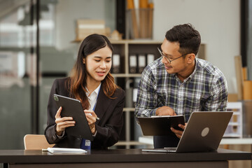 A middle-aged businessman, a young businesswoman, and Asian individuals are collaborating at desks. They engage in teamwork while managing commodities, trade, finance, and talent acquisition.