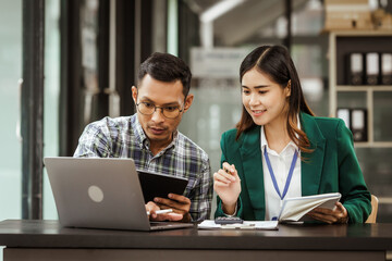 A middle-aged businessman, a young businesswoman, and Asian individuals are collaborating at desks. They engage in teamwork while managing commodities, trade, finance, and talent acquisition.