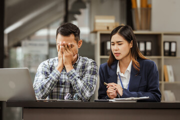 Young businesswoman and other Asian individuals are seen working at desks. Accountability, faultfinding, negligence, and other aspects of recruitment, staffing, and talent management being discussed.