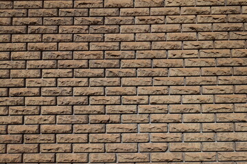 Background - brown split face brick veneer wall with stretcher bond pattern