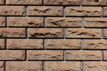 Close shot of brown split face brick veneer wall with stretcher bond pattern